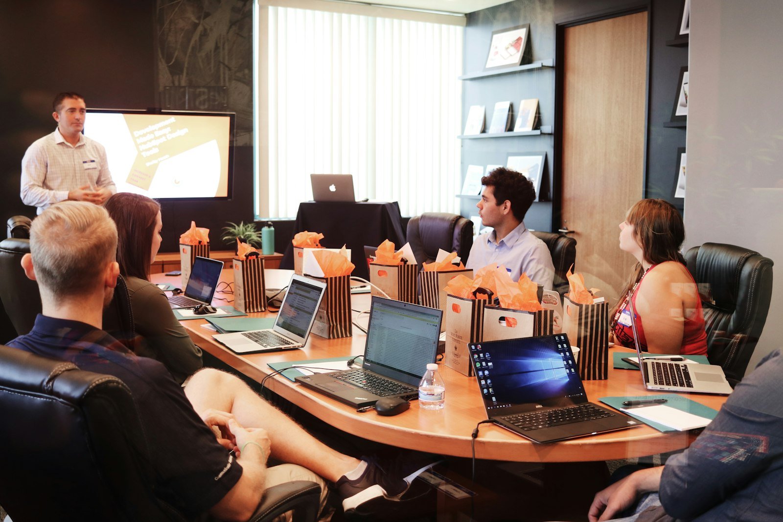 A presenter leading a strategy session with a team around a conference table