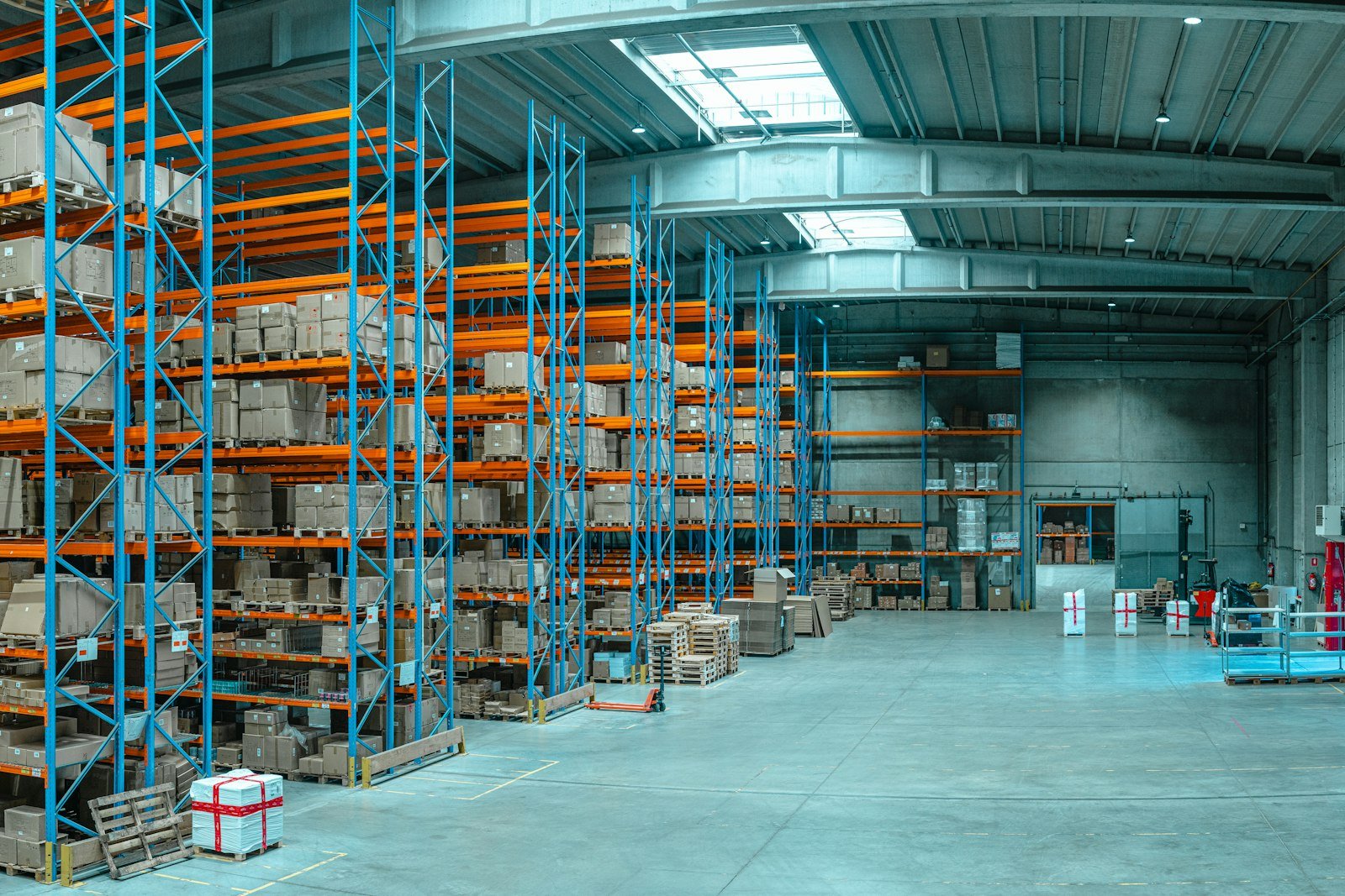 A large warehouse with tall shelving units stocked with boxes